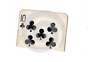 A torn half of a vintage ten of clubs playing card.