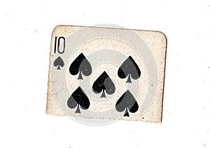 A torn half of a vintage ten of spades playing card.