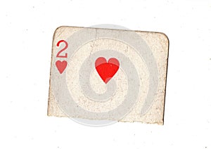 A torn half of a vintage two of hearts playing card.