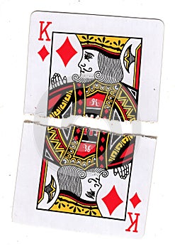 Torn halves of a king of diamonds playing card.