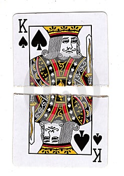 Torn halves of a king of spades playing card.