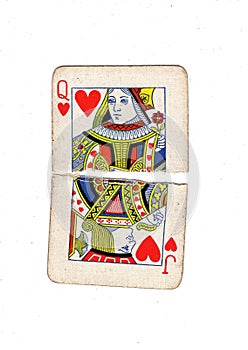 Torn halves of vintage playing cards showing a queen and jack of hearts.