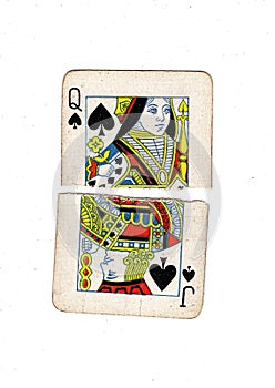 Torn halves of vintage playing cards showing a queen and jack of spades.