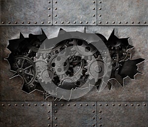 Torn hole in old metal with rusty gears and cogs