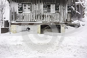 Torn house covered in snow - horizontal