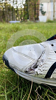 Torn leather sneakers. Leather shoes. Torn shoes. Shoe repair.Footwear for outdoor activities,close up,selective focus