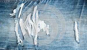 Torn old blue jeans texture