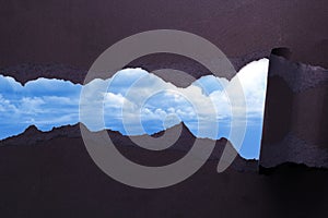 Torn Paper with blue sky background