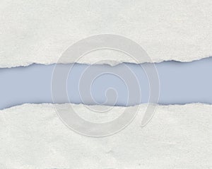 Torn paper edge showing a light blue background with copy space