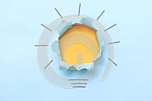 Torn paper light bulb background concept