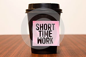 torn paper revealing a document with the text SHORT TIME WORK