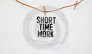torn paper revealing a document with the text SHORT TIME WORK