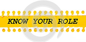 Torn paper strip on yellow background with text KNOW YOUR ROLE