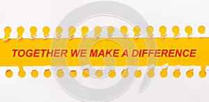 Torn paper strip on yellow background with text TOGETHER WE MAKE A DIFFERENCE