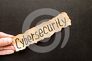 Torn paper with text CYBERSECURITY