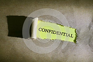 Torn paper with word CONFIDENTIAL