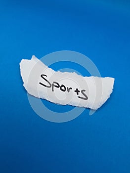 Torn paper with the word sports on it
