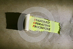 Torn paper with word STANDARD OPERATING PROCEDURE