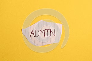 Torn paper written with text ADMIN isolated on yellow background