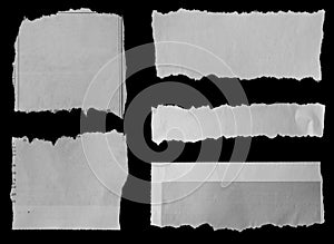 Torn papers on black