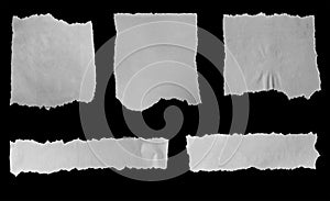 Torn papers on black