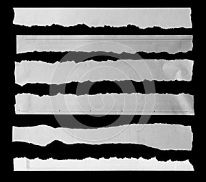 Torn papers on black