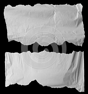 Torn papers on black