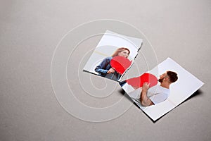 Torn photo of happy couple on grey background. Concept of divorce