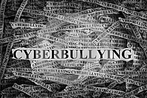 Torn pieces of paper with word Cyberbullying