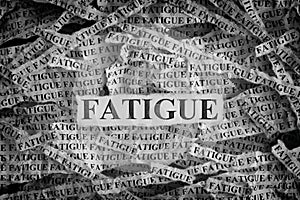 Torn pieces of paper with the word Fatigue