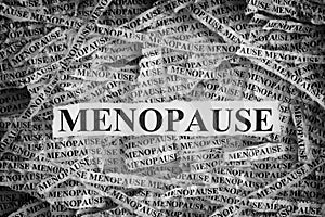 Torn pieces of paper with the word Menopause photo