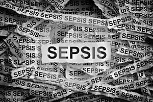 Torn pieces of paper with the word Sepsis photo