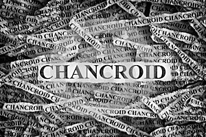 Torn pieces of paper with the words Chancroid