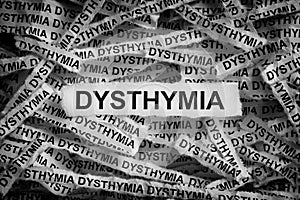 Torn pieces of paper with the words Dysthymia