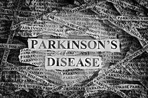 Torn pieces of paper with the words Parkinson`s disease