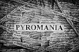 Torn pieces of paper with the words Pyromania photo