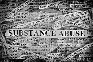 Torn pieces of paper with the words Substance Abuse photo