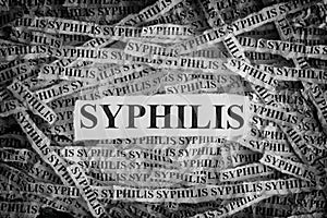 Torn pieces of paper with the words Syphilis