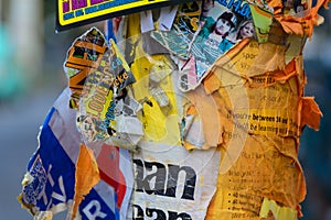 Torn posters on lamp post in Berlin