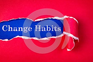 Torn red Paper and Change Habits text with a blue paper backgro