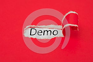 Torn red paper revealing the word Demo. Business concept