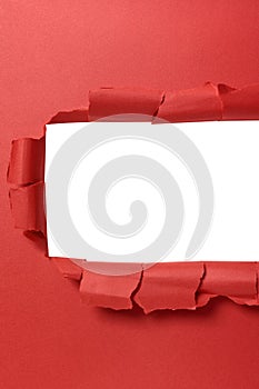 Torn red paper strip with white background, copy space vertical