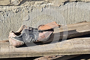 A torn shoe lies on the boards.