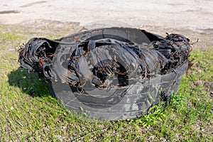 A torn tire from a truck. Old tires left on the side of the road