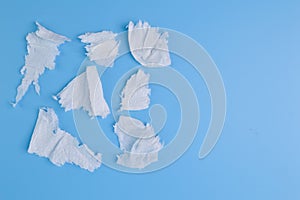Torn tissue papers isolated on a blue background