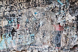 Torn and weathered advertisement posters on a wall