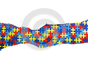 Torn white paper on multicolored puzzle background. Cocept for autism awareness day. Break barriers together for autism.