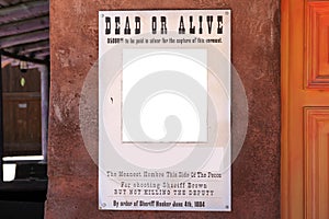 Torn Wild West wanted poster on wall