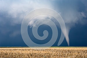 Tornado with dark clouds and stormy sky