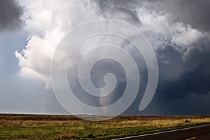 Tornado spins across a field near Ensign, Kansas.